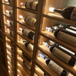 (4) Custom triple deep wooden racks are perfect for small basement wine cellars.